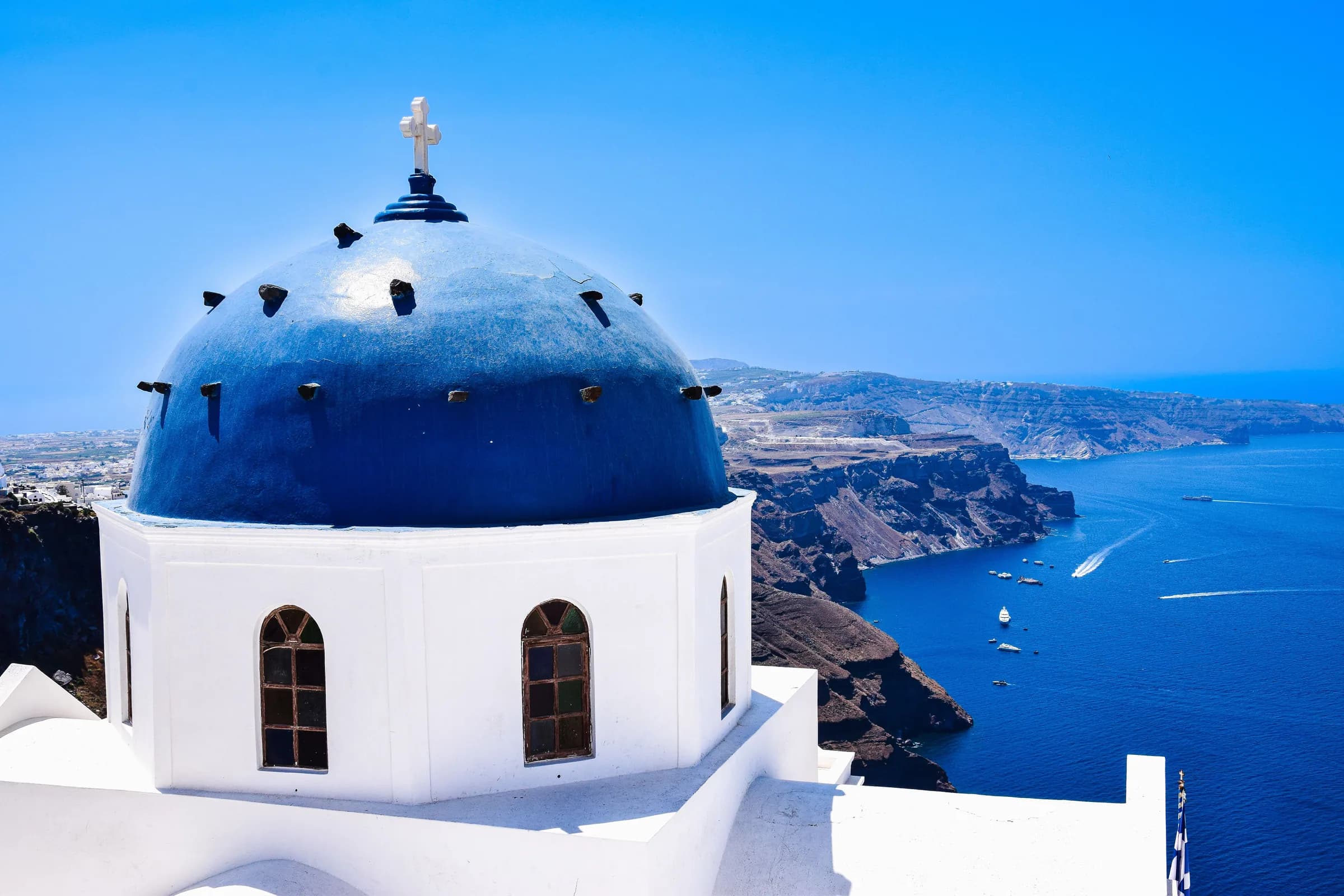 Blue-domed church above the Aegean, Cyclades, Greece