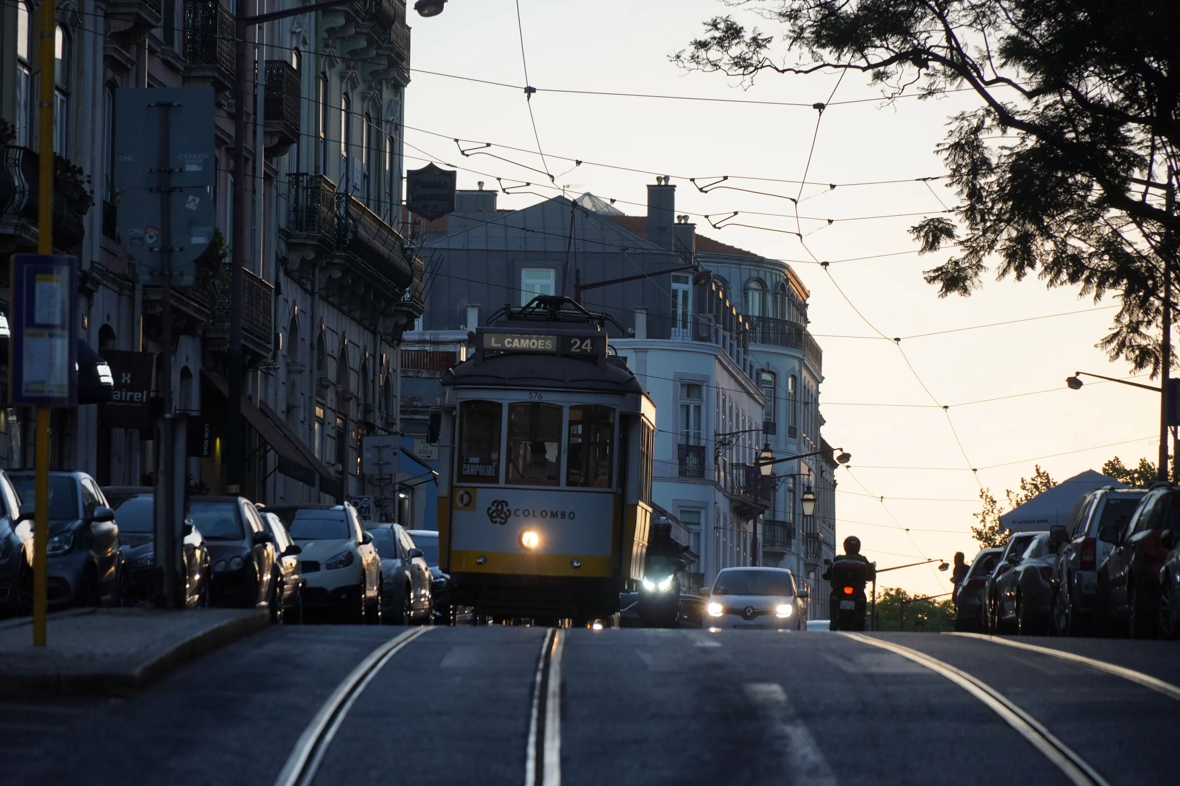 Historic tram climbing a Lisbon street at dusk, Portugal